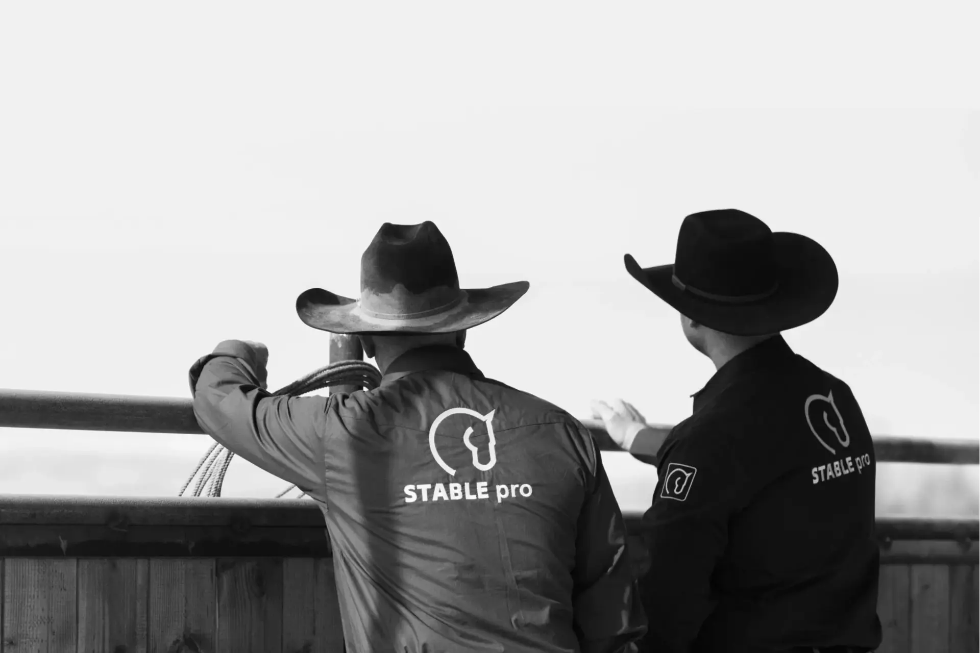 Two members of the STABLE pro team watching the arena from the rail.